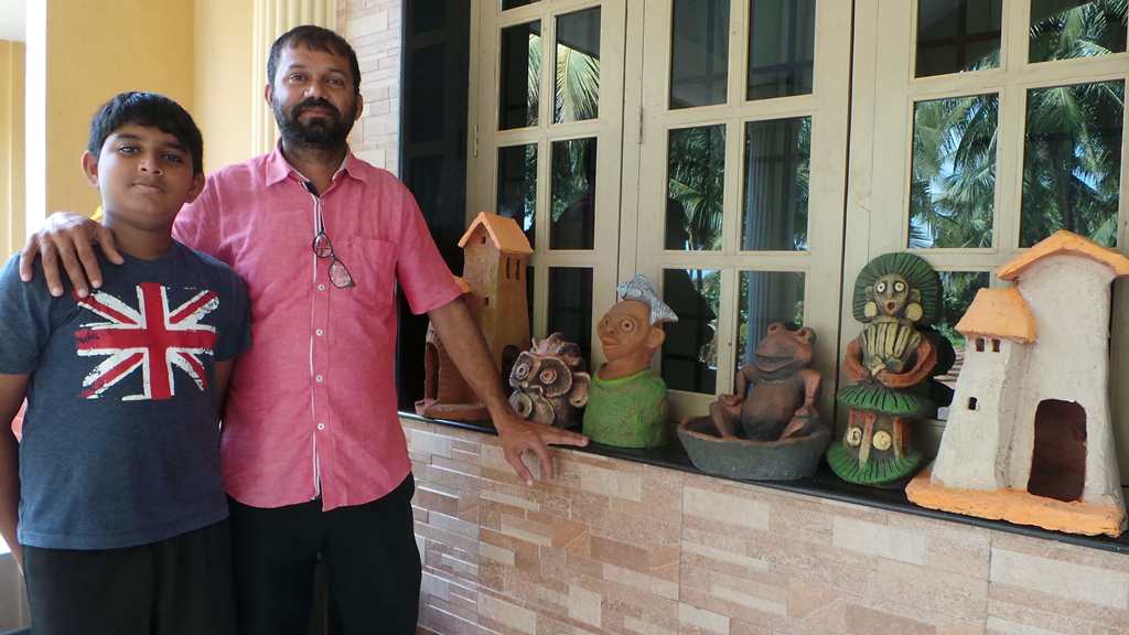 Laren Pinto all of 14 years and a sample of his work in the background Terracotta Artist Venki Palimar with award winning student Laren Pinto