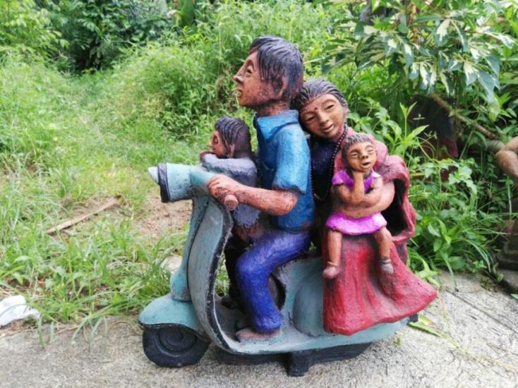 The scooter and the happy family in terracotta at Chitralaya Art Gallery Palimar Hamara Bajaj series, remembering the good old days of the scooter. By Terracotta artist Venki Palimar
