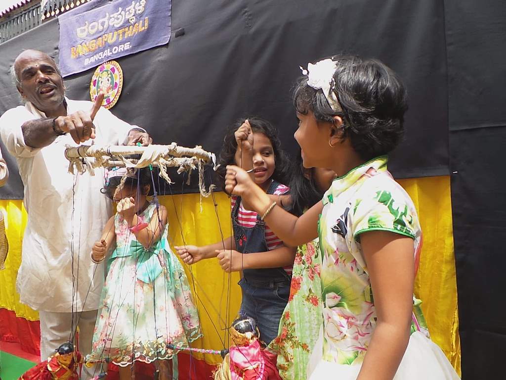 Kids trying out the puppets The Puppet show by Rangaputhali at Sankalpa